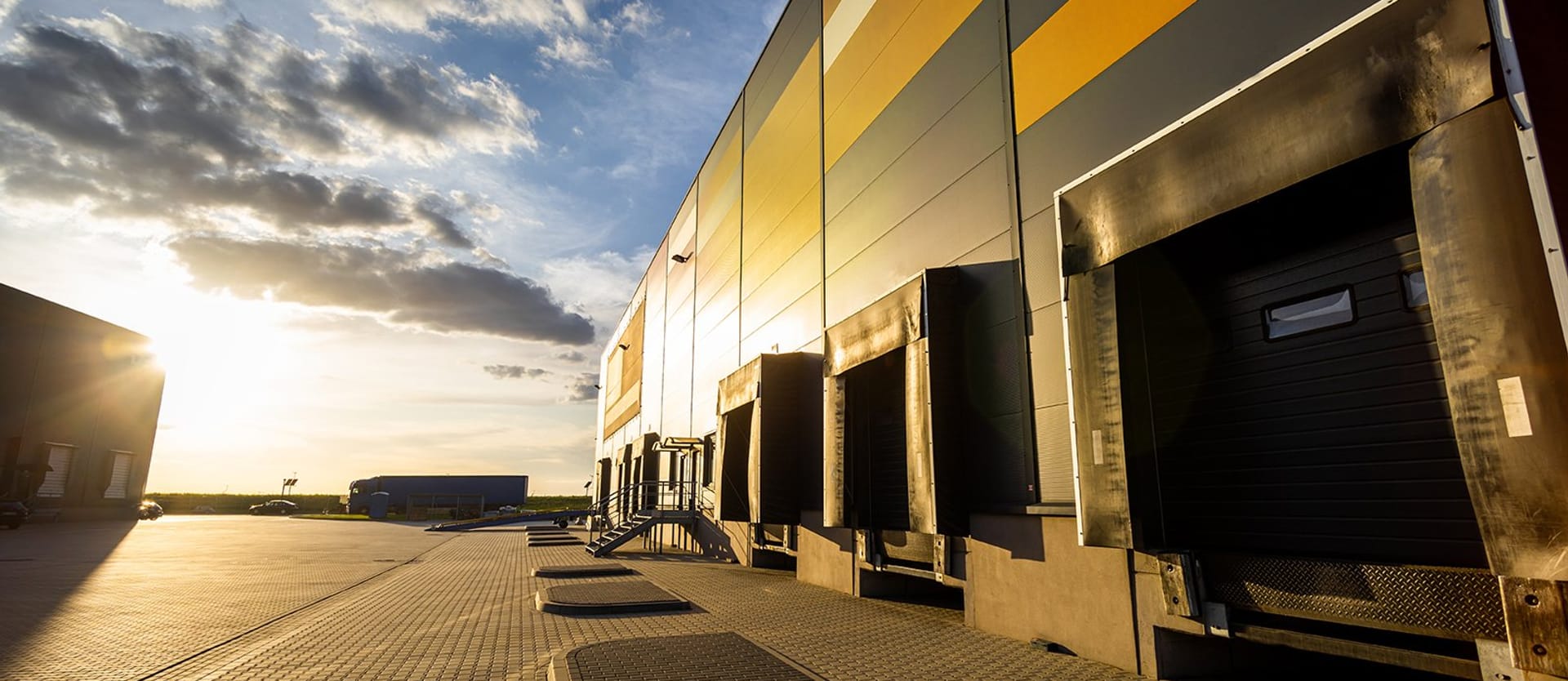 Cargo loading dock doors of big warehouse building, outdoor