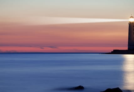 Seascape at sunset. Lighthouse on the coast