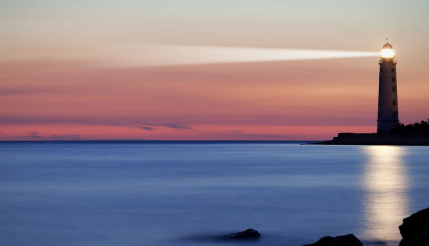 Seascape at sunset. Lighthouse on the coast