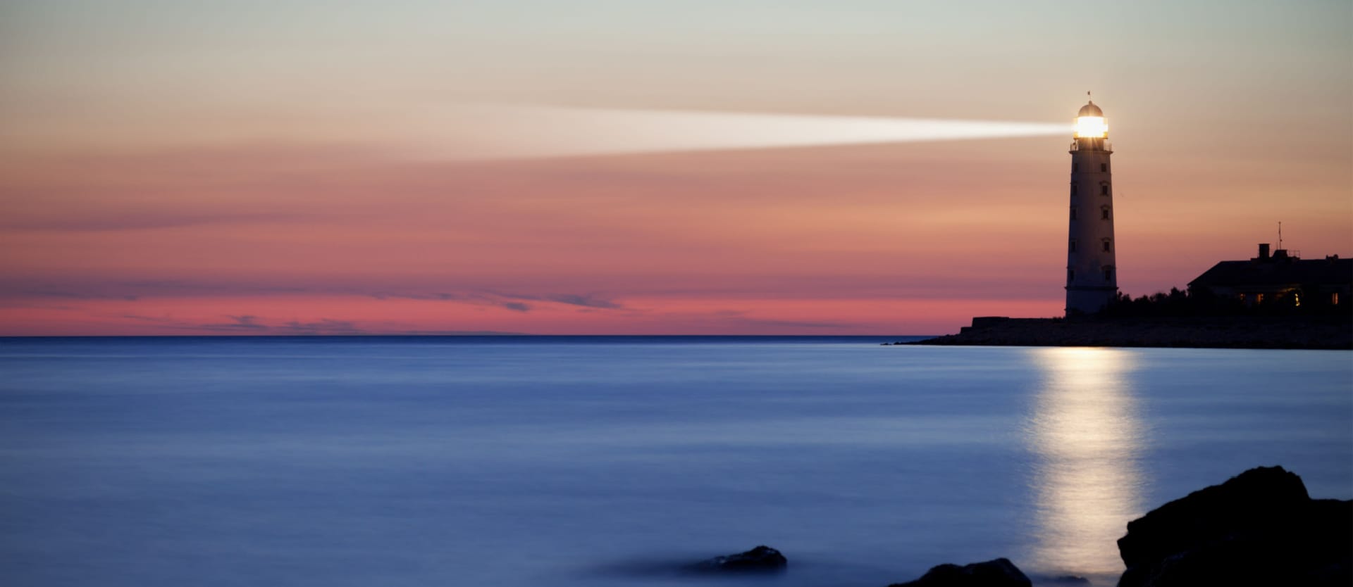 Seascape at sunset. Lighthouse on the coast